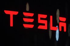 Red Tesla logo with black background