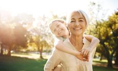 A grandmother gives her granddaughter a piggyback ride