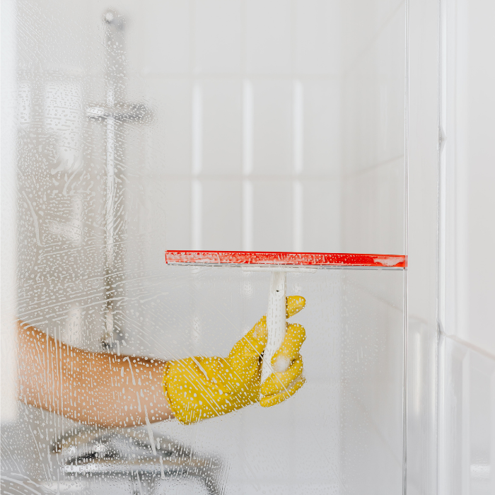 Deep clean shower enclosure glass doors with baking soda and vinegar
