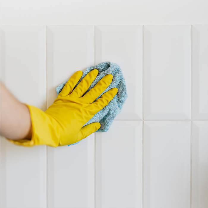 cleaning bathroom wall tile with a cloth